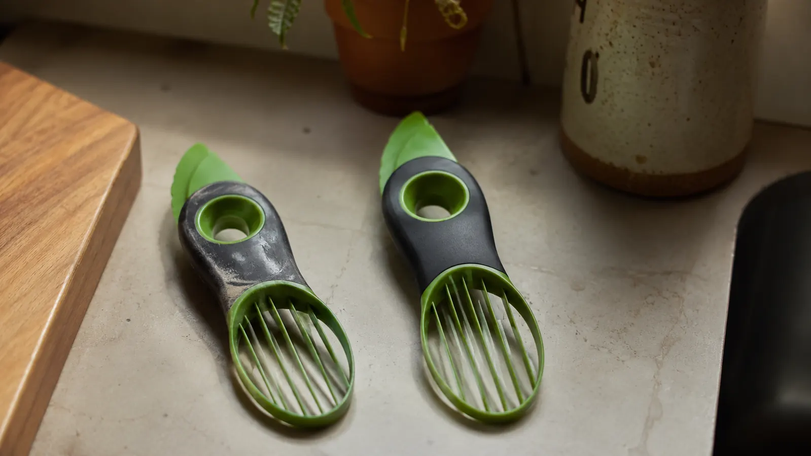 Two avocado tools side by side, one older and scuffed, one newer, showing wear comparison over months of use