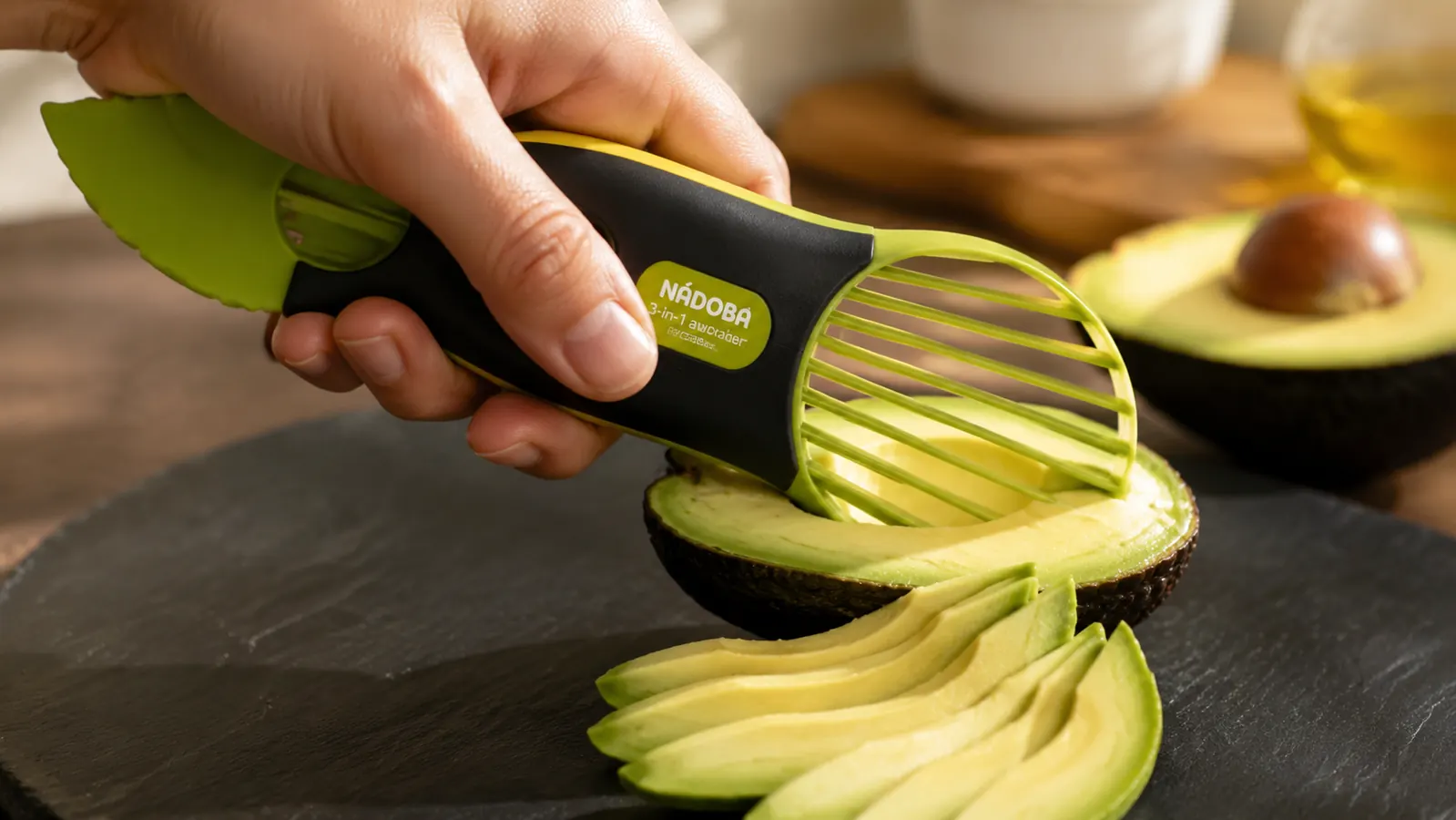 Hand using the avocado tool's fan blade to slice a peeled avocado half into even wedges over a cutting board