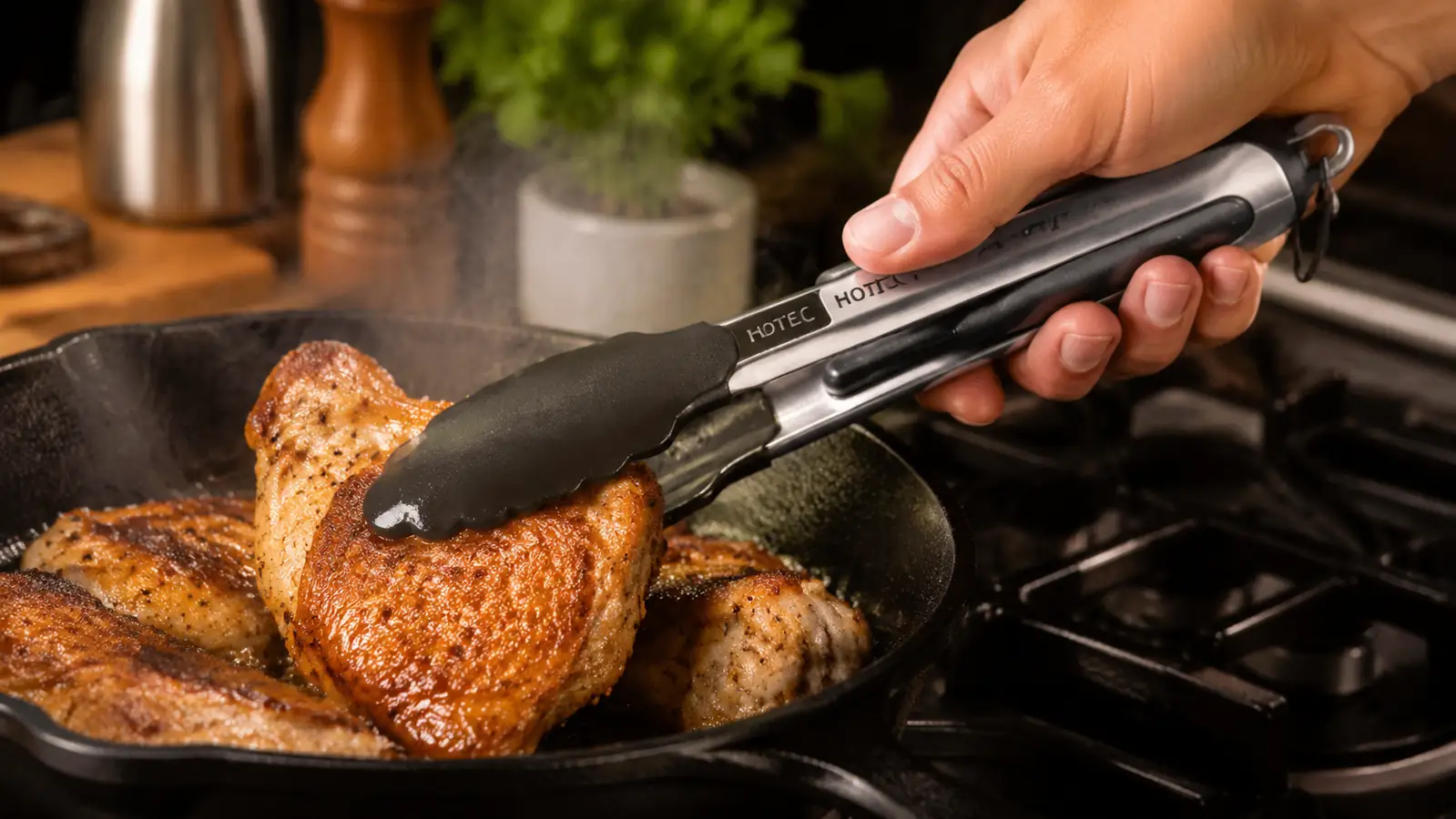 Hand using stainless steel locking tongs to flip a chicken thigh in a cast iron skillet
